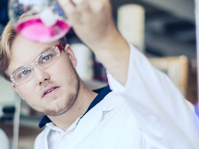 Young man with test tube in a laboratory