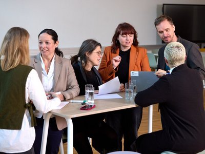 A group of people sitting around a table.