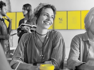 A female student and a male student are sitting together while learning.