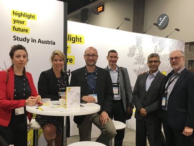 Two women and four men at the exhibition stand