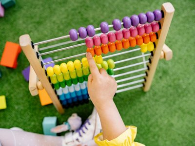 Child Playing With An Abacus and Learning To Count
