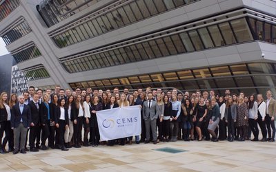 A big group of students from the CEMS Clubs in front of the WU Vienna