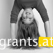 The subject of grants.at shows a young woman with long hair who makes a handstand.