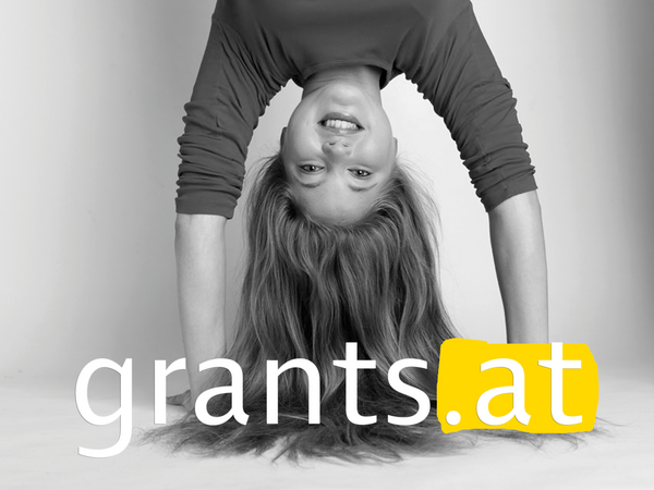 The subject of grants.at shows a young woman with long hair who makes a handstand.