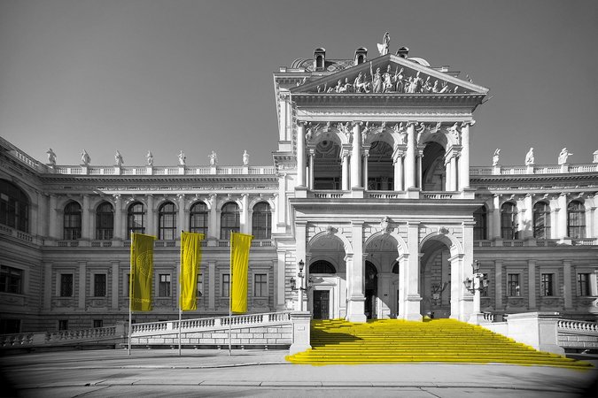 Außenansicht des Haupgebäudes der Universität Wien mit Flaggen