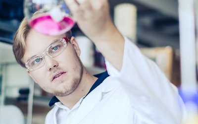 Young man with test tube in a laboratory